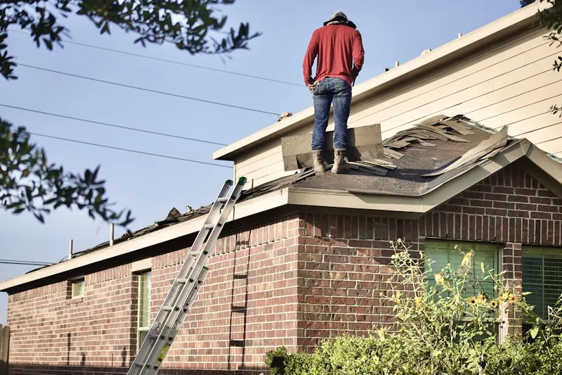 Professional roofer working on a residential roof in Summerfield